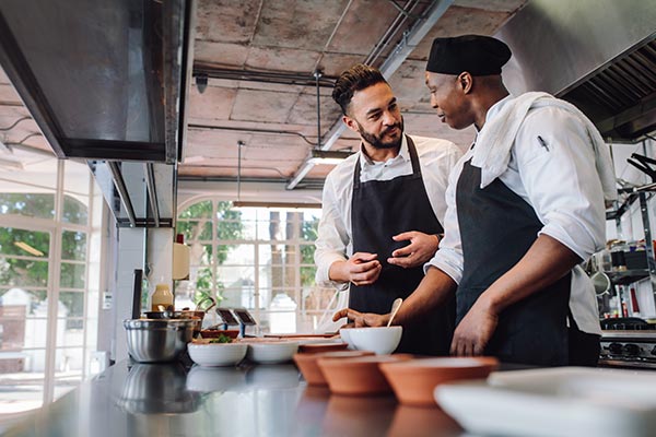 Head chef talking to younger chef